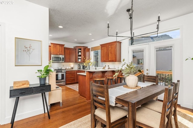 13765 SW Florentine Ave, Portland, OR 97223 - dining room featuring wood finished floors, a textured ceiling, and recessed lighting