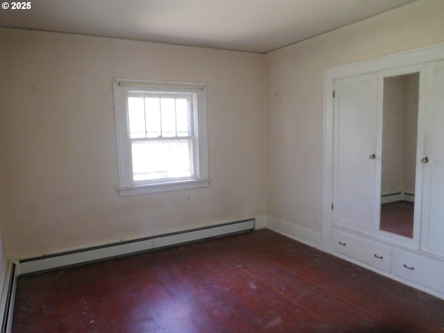 84105 Winesap Rd, Milton-Freewater, OR 97862 - spare room with baseboard heating, dark wood-type flooring, and baseboards