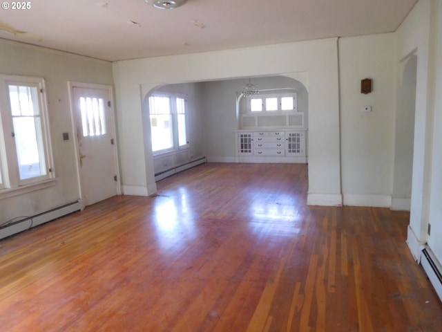 84105 Winesap Rd, Milton-Freewater, OR 97862 - foyer with baseboard heating, arched walkways, and wood finished floors