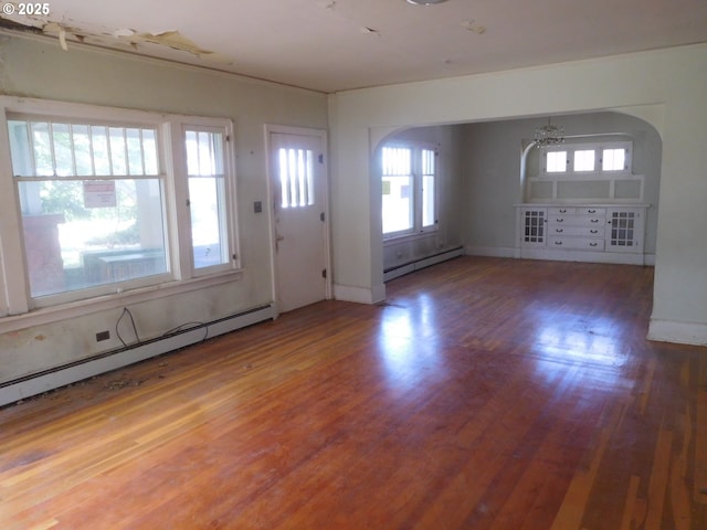 84105 Winesap Rd, Milton-Freewater, OR 97862 - foyer entrance with baseboard heating, wood finished floors, and arched walkways