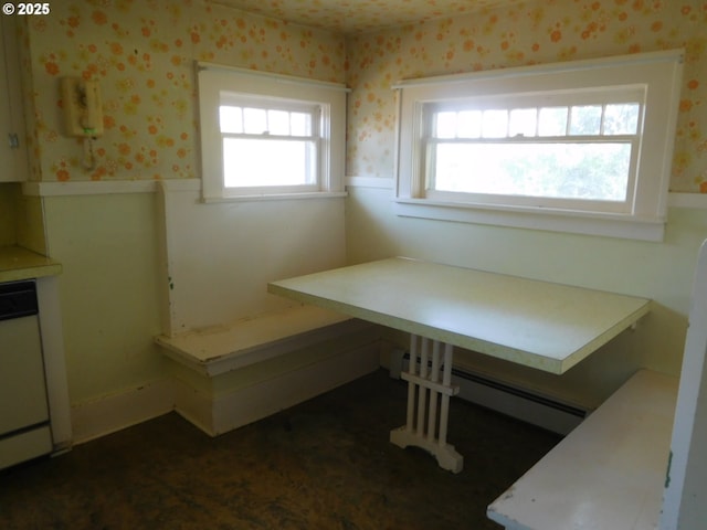 84105 Winesap Rd, Milton-Freewater, OR 97862 - unfurnished dining area featuring wallpapered walls, a wainscoted wall, and a baseboard heating unit