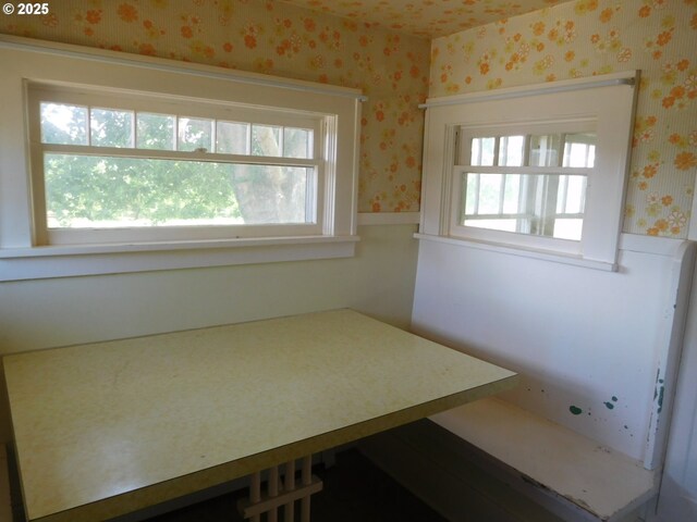 84105 Winesap Rd, Milton-Freewater, OR 97862 - unfurnished bedroom with wallpapered walls, a wainscoted wall, and multiple windows