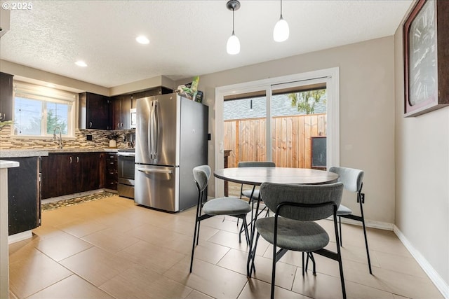 dining area with recessed lighting, baseboards, and a textured ceiling