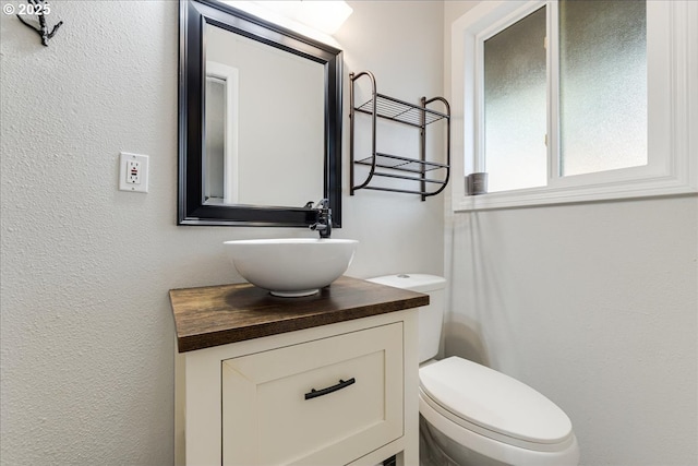 bathroom with toilet and vanity