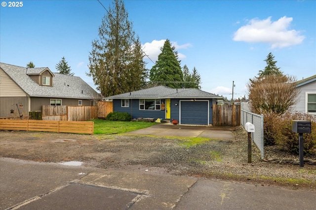 view of front of property featuring a fenced front yard, a garage, and concrete driveway