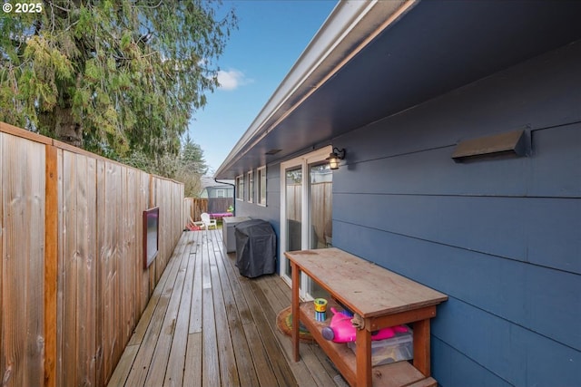 wooden terrace featuring fence