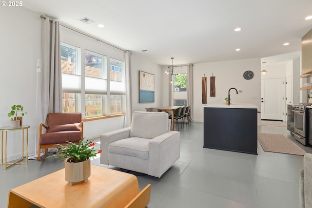 living area featuring visible vents and recessed lighting