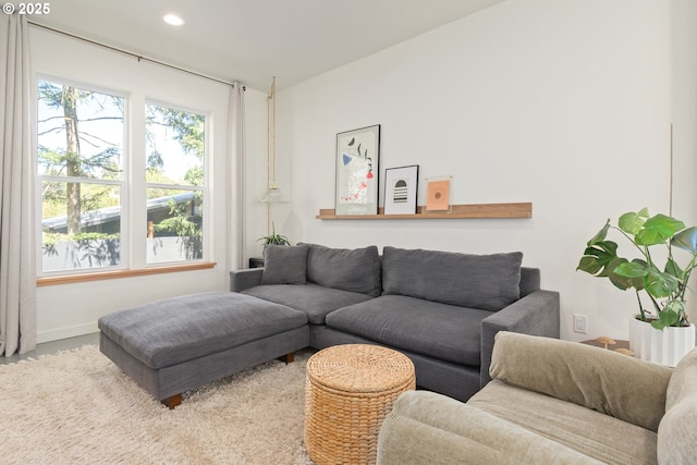 living area featuring baseboards and recessed lighting