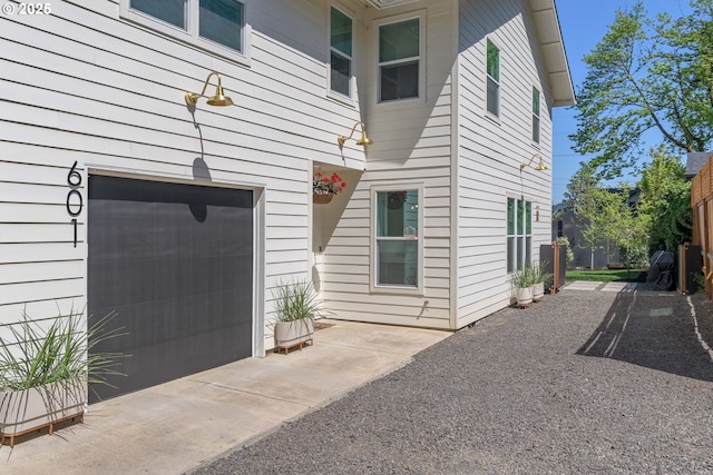 view of side of property featuring a garage and driveway