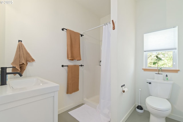 full bath featuring baseboards, vanity, toilet, and a shower stall