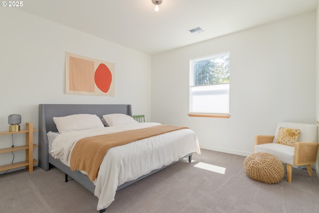 carpeted bedroom featuring baseboards and visible vents
