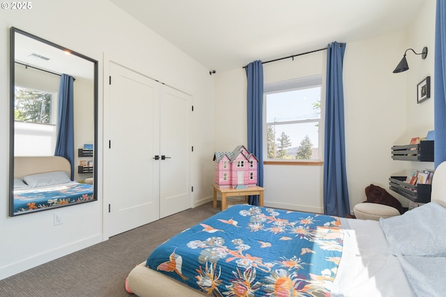 carpeted bedroom with baseboards, multiple windows, a closet, and visible vents