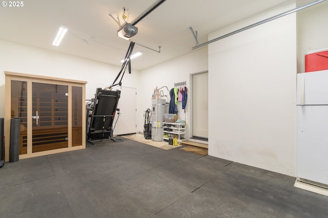 garage with freestanding refrigerator, a garage door opener, and water heater