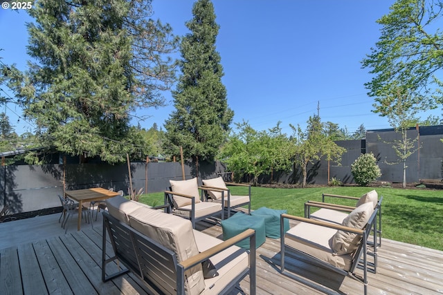 wooden deck featuring a lawn, a fenced backyard, an outdoor hangout area, and outdoor dining space