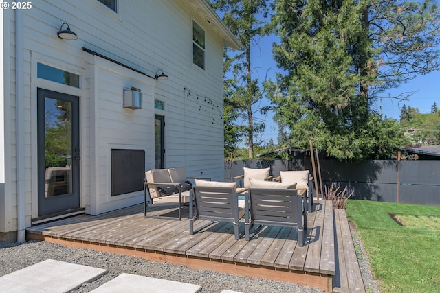 wooden terrace featuring outdoor lounge area, fence, and outdoor dining space