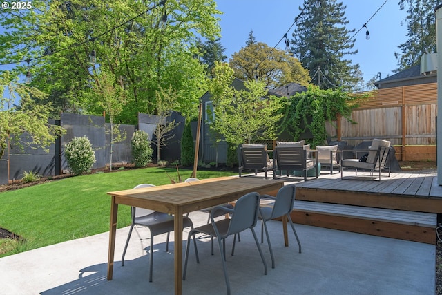view of patio featuring outdoor dining area, a fenced backyard, and a deck