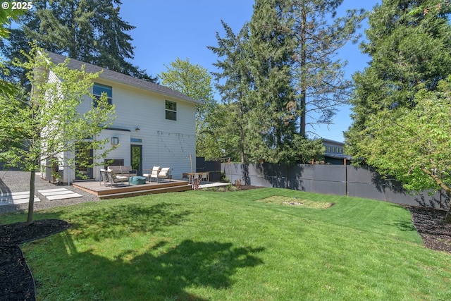 back of property featuring fence, an outdoor living space, a yard, and a deck
