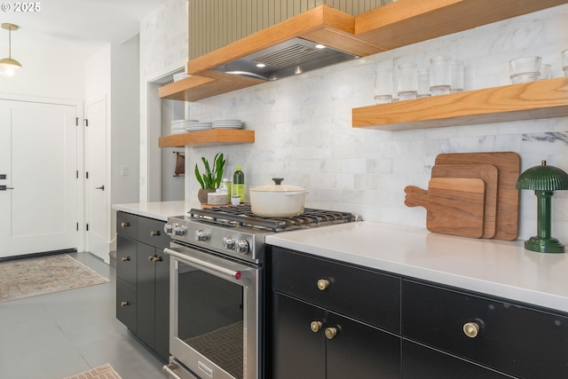 kitchen with open shelves, high end stainless steel range, light countertops, tasteful backsplash, and dark cabinetry