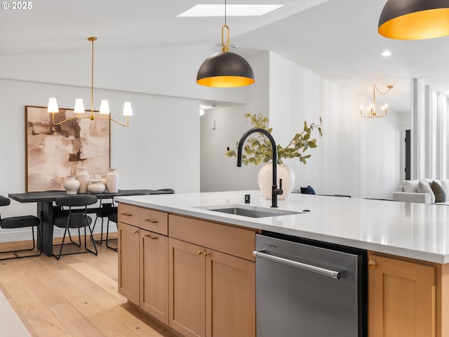 kitchen with an inviting chandelier, sink, dishwasher, light brown cabinetry, and hanging light fixtures