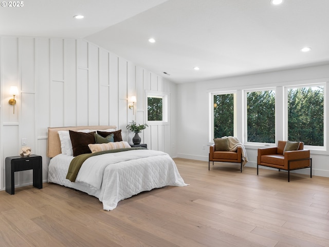 bedroom with light hardwood / wood-style flooring and lofted ceiling