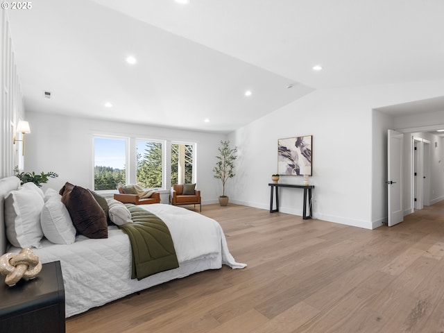 bedroom featuring light hardwood / wood-style floors and vaulted ceiling