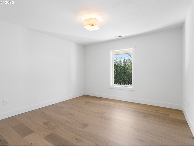 unfurnished room with light hardwood / wood-style floors