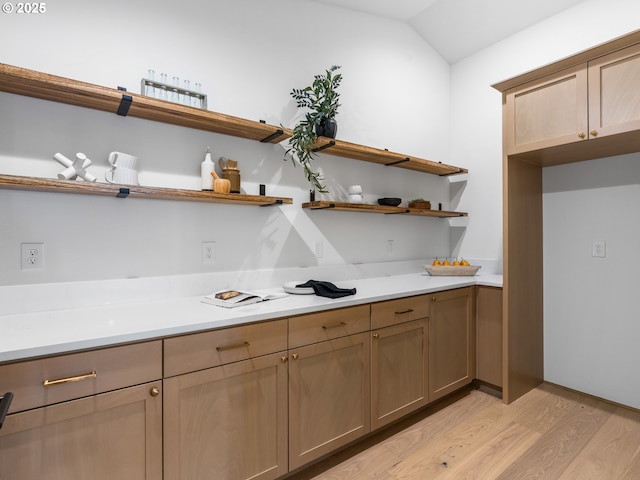 kitchen with vaulted ceiling and light hardwood / wood-style floors