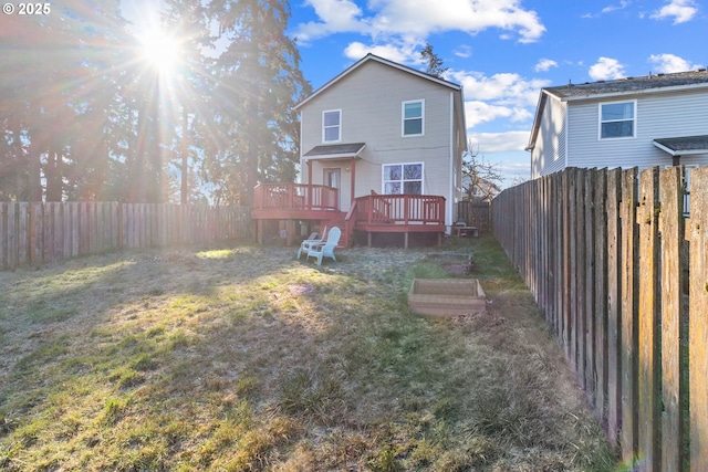 back of house with a lawn and a deck