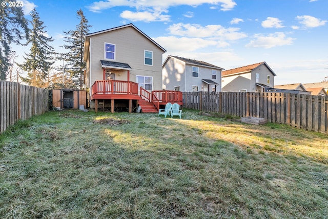 back of house with a wooden deck and a lawn