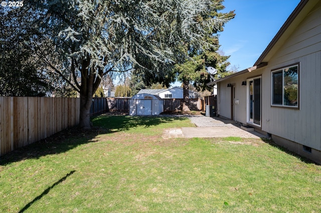 view of yard featuring a fenced backyard, an outdoor structure, and a storage shed