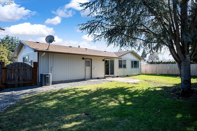 back of house with crawl space, a gate, fence, a yard, and central air condition unit