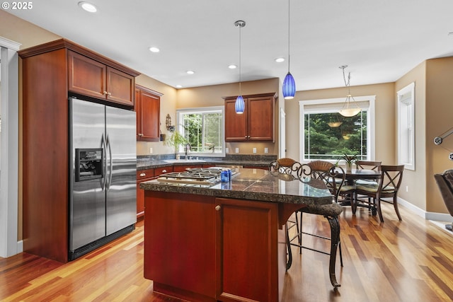 12919 NE 37th Ct, Vancouver, WA 98686 - kitchen with stainless steel appliances, light wood-style floors, a breakfast bar area, pendant lighting, and recessed lighting