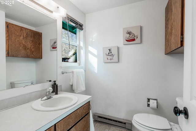 bathroom featuring a baseboard radiator, vanity, and toilet