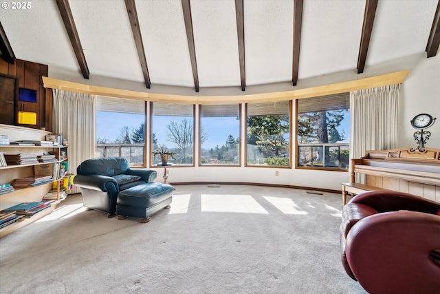 interior space featuring visible vents and vaulted ceiling with beams