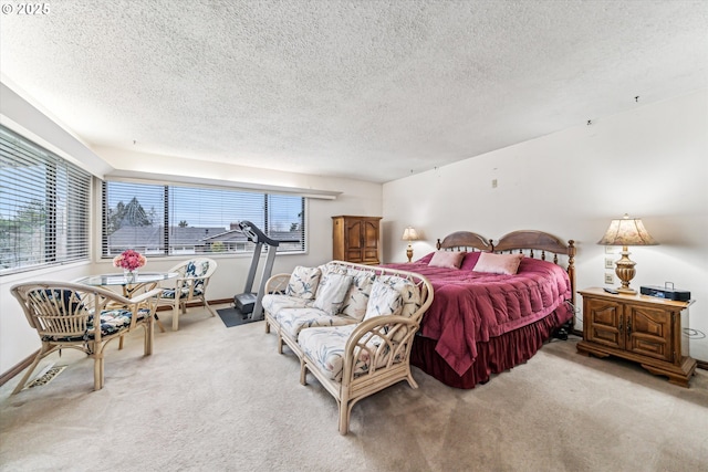 bedroom featuring light carpet, baseboards, visible vents, and a textured ceiling