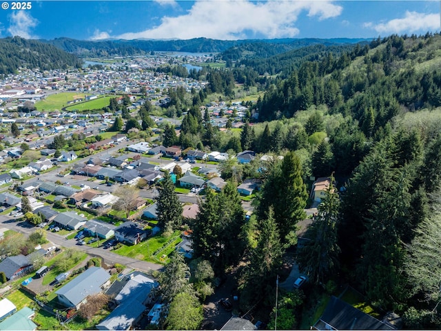 aerial view with a mountain view and a wooded view