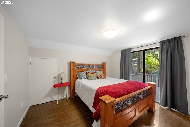 bedroom featuring baseboards, vaulted ceiling, wood finished floors, and access to outside