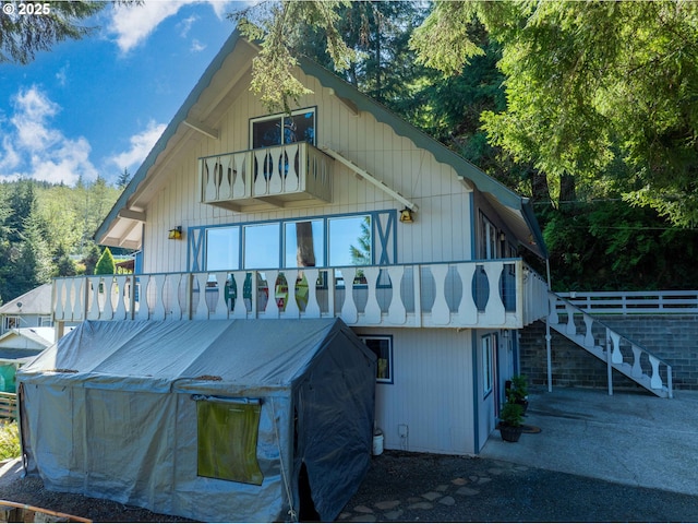 back of property featuring stairs