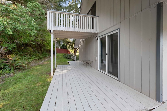 wooden terrace featuring a yard