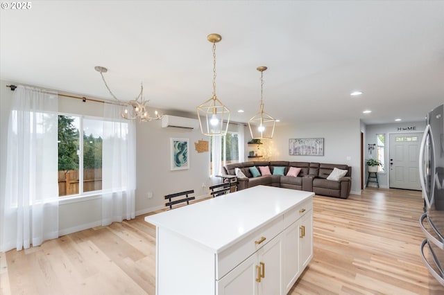 110 Axis Rd, Castle Rock, WA 98611 - kitchen featuring a wall mounted air conditioner, freestanding refrigerator, healthy amount of natural light, light wood-style floors, and recessed lighting