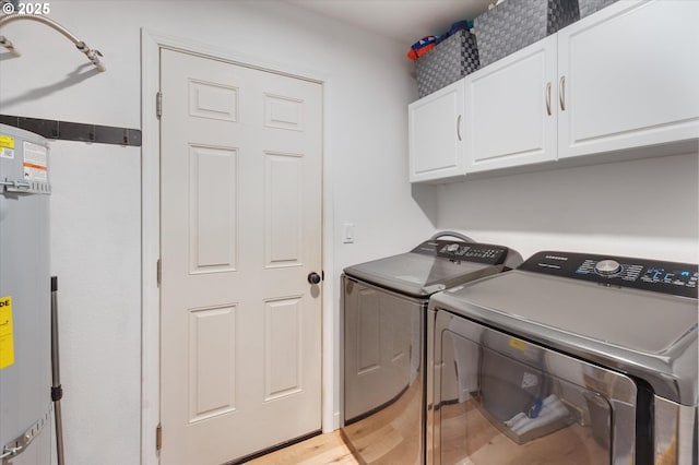 110 Axis Rd, Castle Rock, WA 98611 - laundry room with cabinet space, independent washer and dryer, light wood finished floors, and strapped water heater