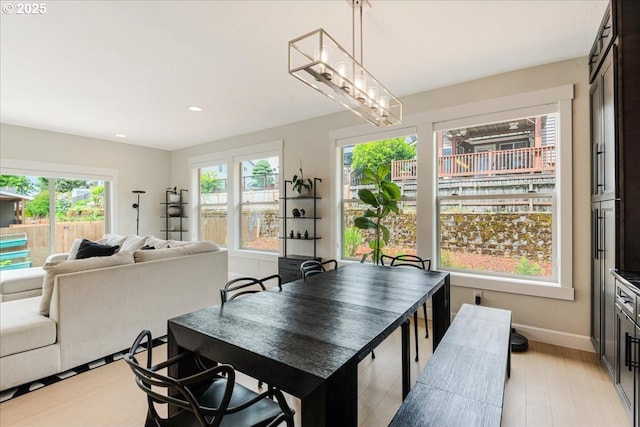 dining area featuring recessed lighting, light wood-style floors, and baseboards