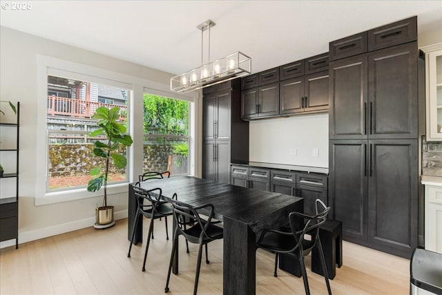 3779 SW Mckinley St, Gresham, OR 97080 - dining space with light wood finished floors, a chandelier, and baseboards