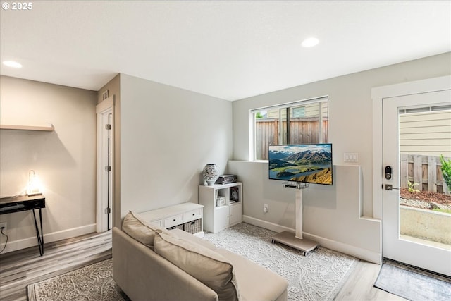 living room featuring light wood-type flooring, recessed lighting, and baseboards