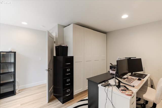home office featuring light wood finished floors, recessed lighting, and baseboards