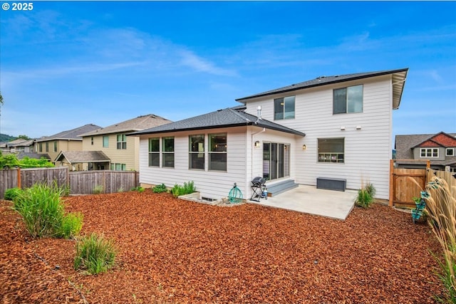 rear view of house featuring a patio area and a fenced backyard