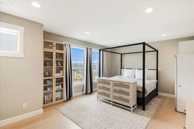 3779 SW Mckinley St, Gresham, OR 97080 - bedroom with light wood-type flooring, recessed lighting, baseboards, and freestanding refrigerator