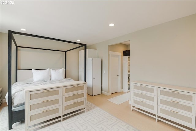bedroom featuring light wood finished floors and recessed lighting