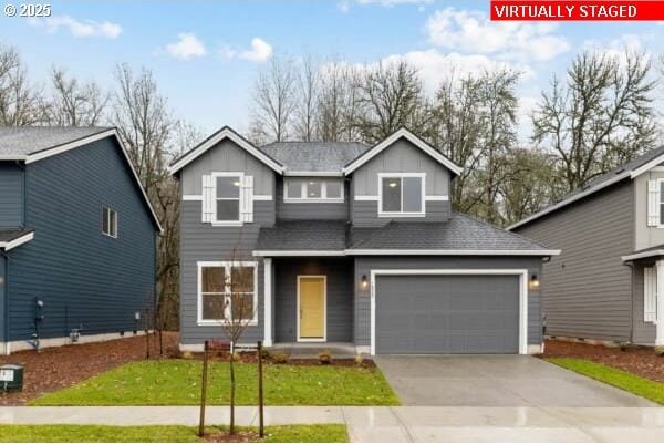 10494 SE Reverent Rd Unit 315, Happy Valley, OR 97086 - traditional-style house with an attached garage, a front lawn, board and batten siding, and concrete driveway