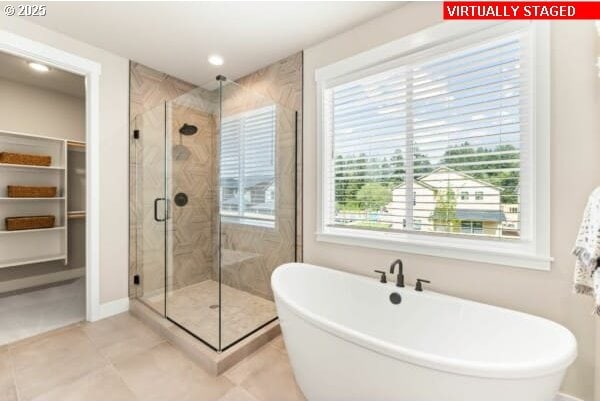 10494 SE Reverent Rd Unit 315, Happy Valley, OR 97086 - bathroom with a walk in closet, a freestanding bath, a stall shower, tile patterned floors, and recessed lighting